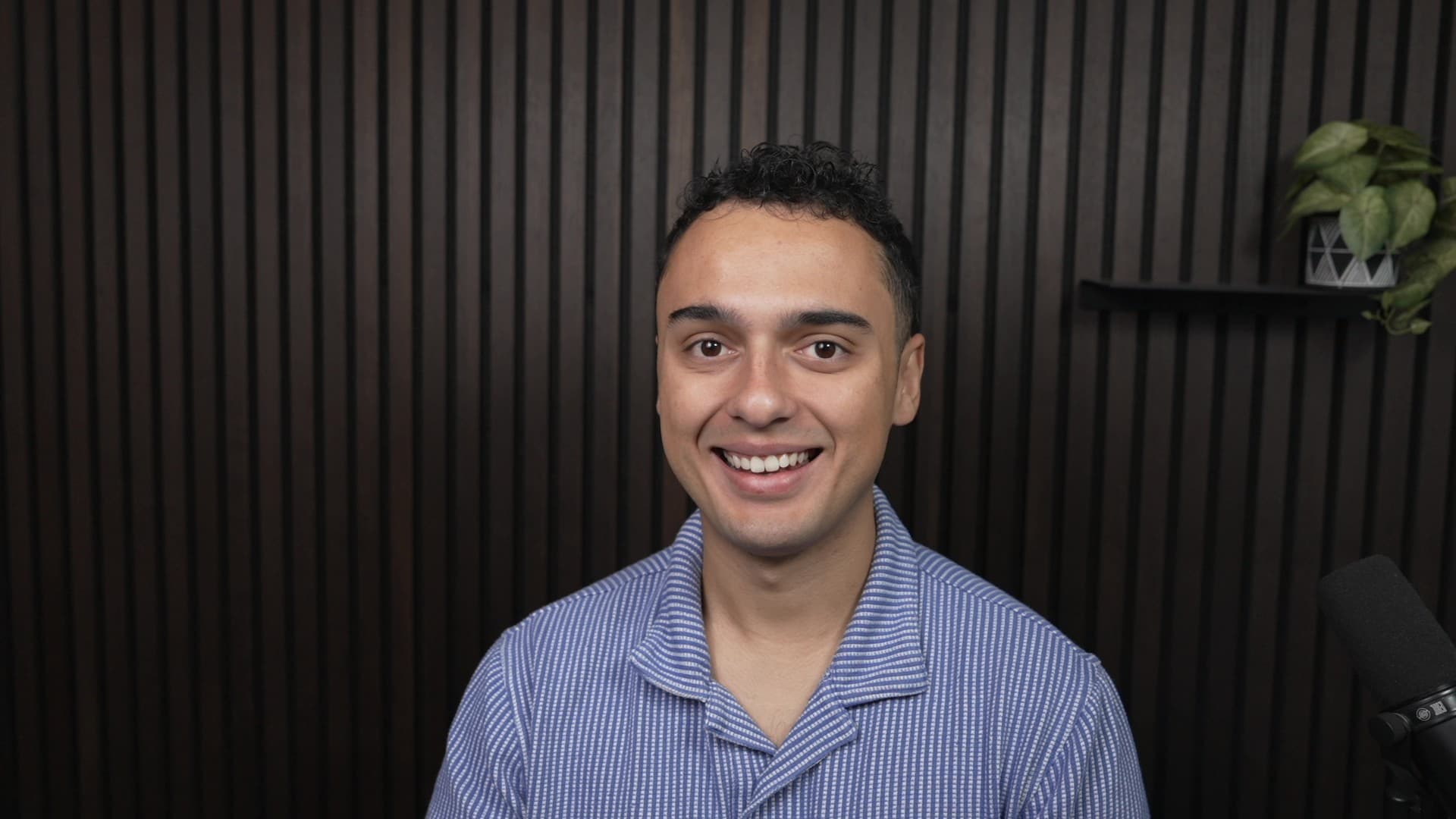 Jesus Martinez smiling at the camera in his studio